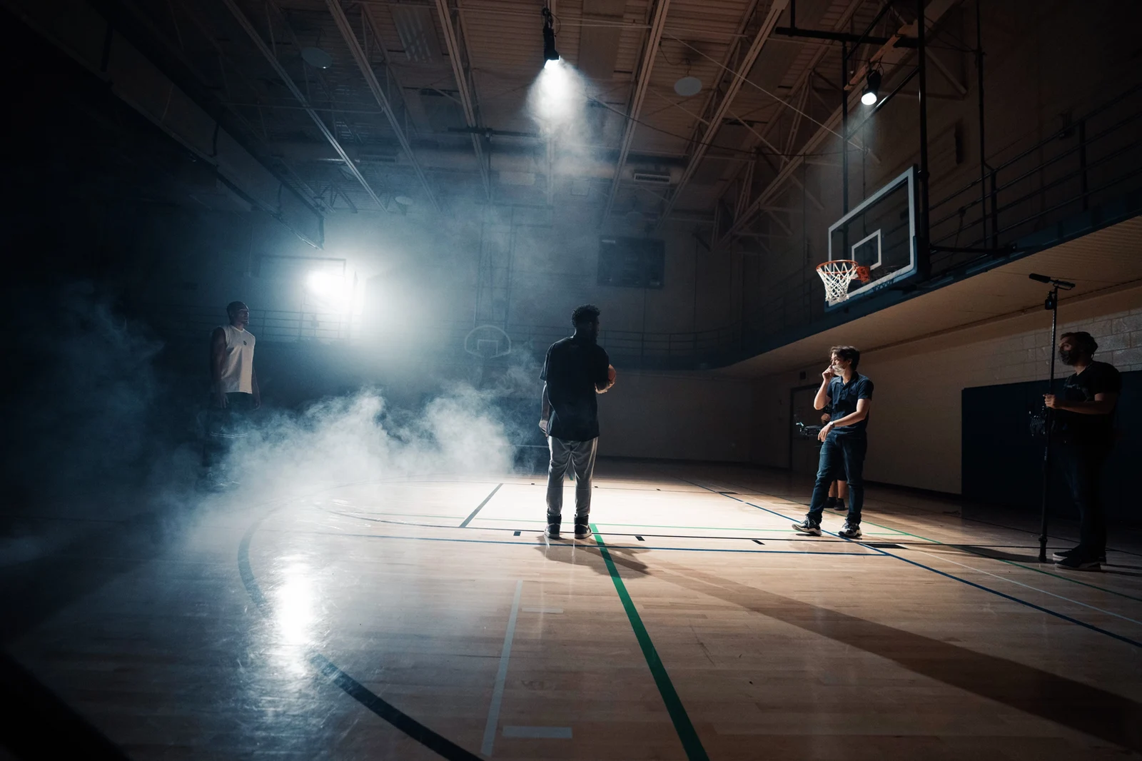 A film crew working on a basketball court