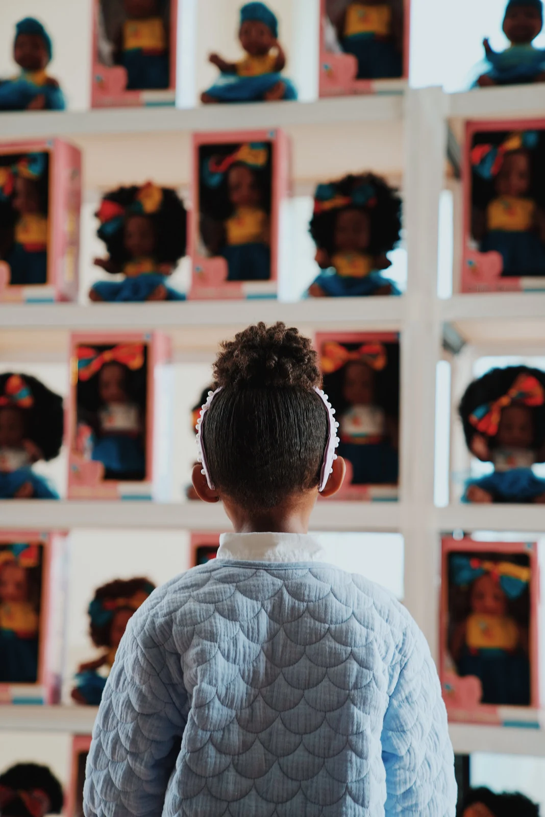 A portrait framed by a wall of photographs