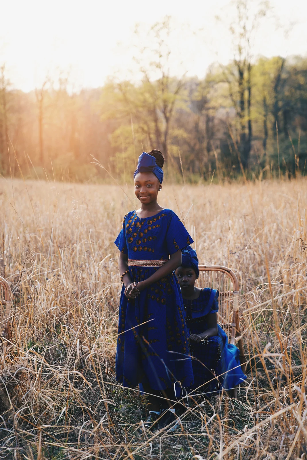 A woman and child standing in a golden field