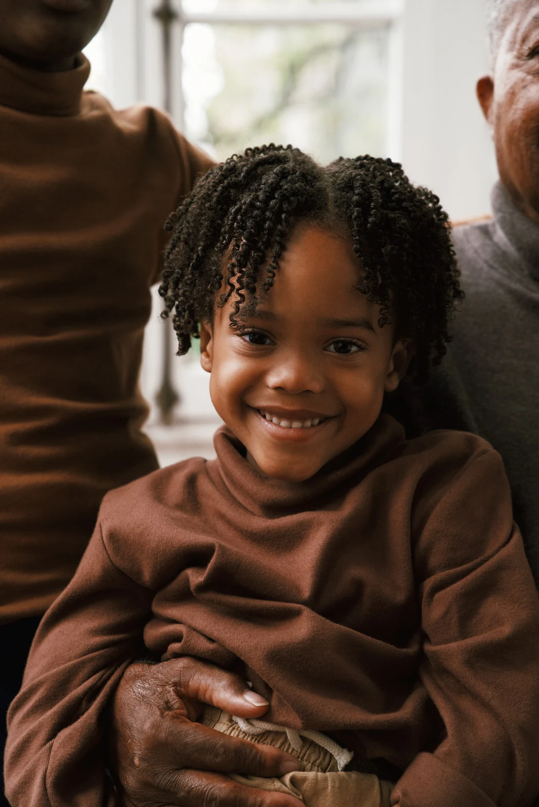 A young child smiling at the camera