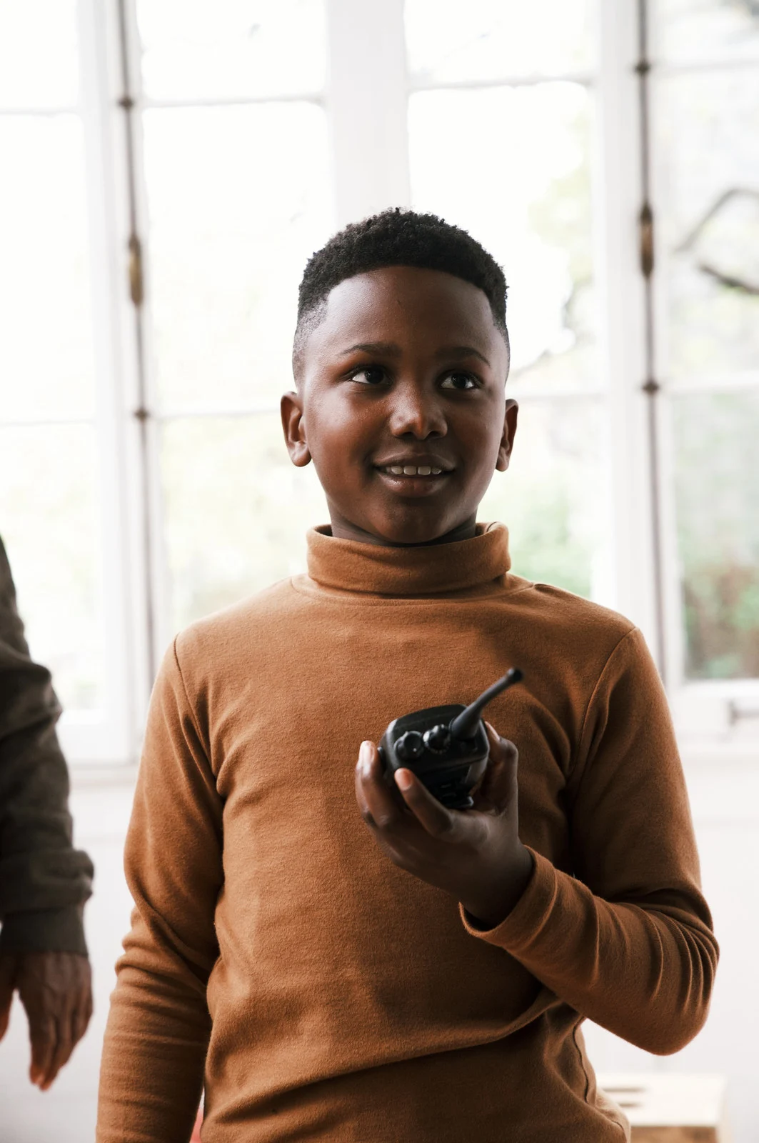A smiling child holding a camera