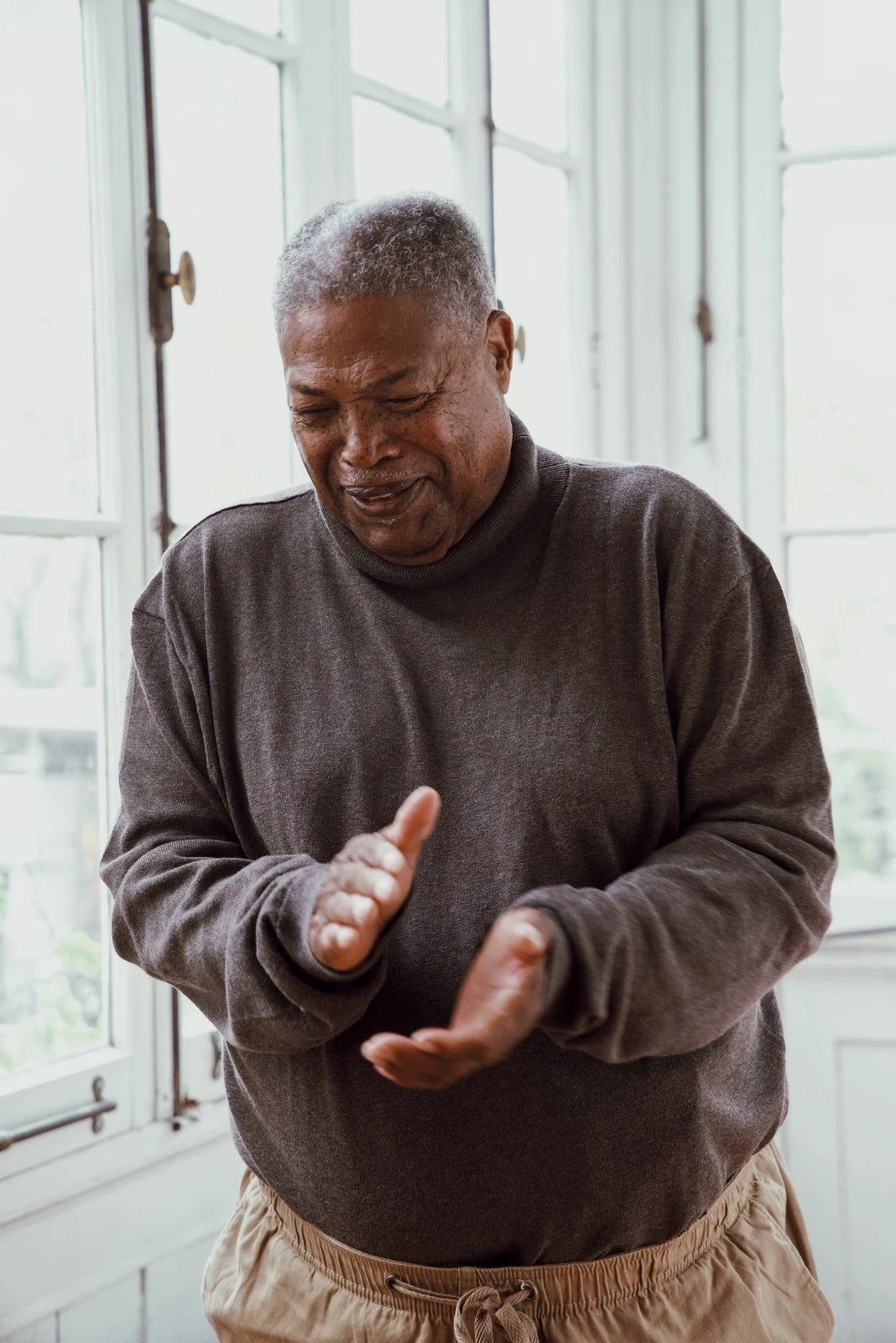 A man speaking with expressive hands