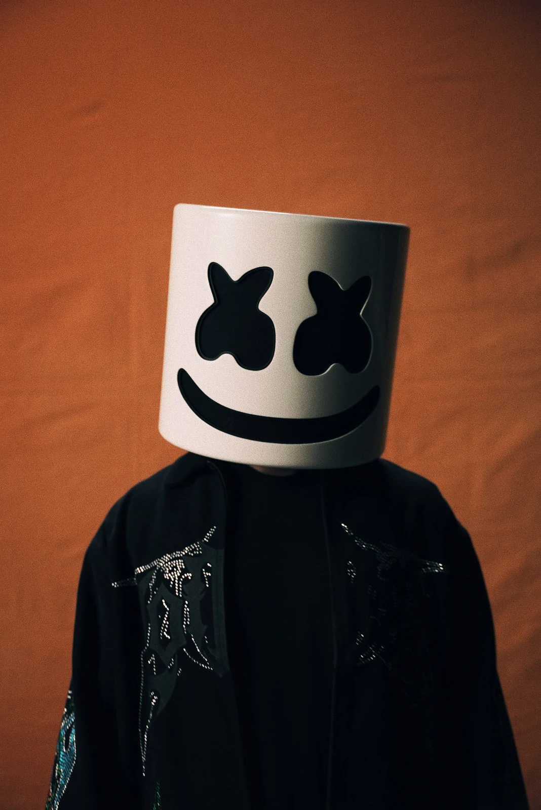 Marshmello against an orange wall