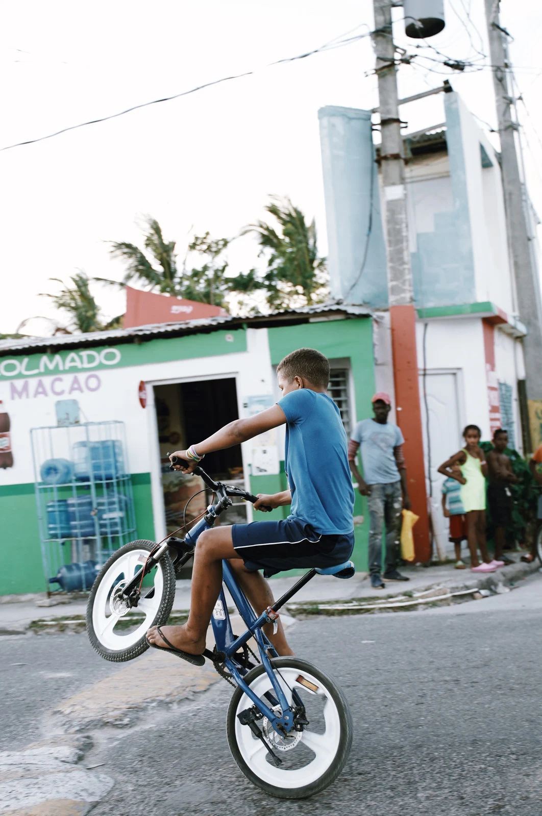 A street scene beside a green storefront