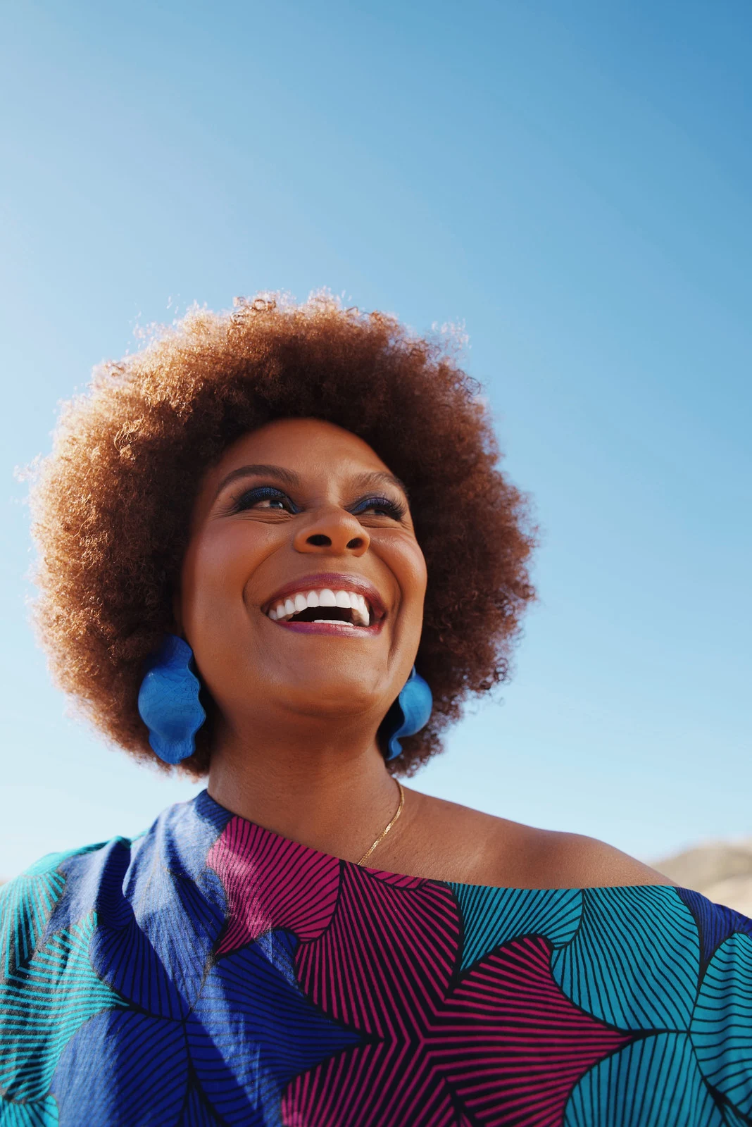 A smiling woman in sunlight